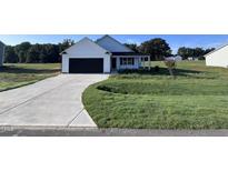 New home with a two-car garage and landscaped yard at 194 Lotus Ave, Smithfield, NC 27577