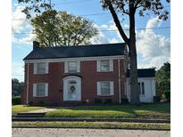 Brick two-story house with a large front yard and mature trees at 110 S Layton Avenue, Dunn, NC 28334