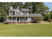 Two-story gray house with a large front yard at 1001 Yopon Ct, Raleigh, NC 27603