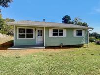 Newly painted light green ranch home with a yard at 225 W Orange St, Hillsborough, NC 27278