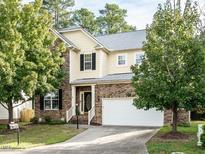 Two-story house with stone and siding exterior, large windows, and a two-car garage at 1040 Bellenden Dr, Durham, NC 27713