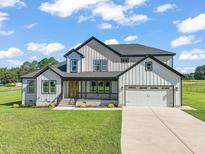 Modern farmhouse exterior with two-car garage at 2804 Jack Mitchell Rd, Zebulon, NC 27597