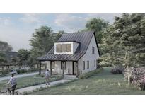 Modern farmhouse exterior with metal roof and covered porch at 109 Jones Ave, Hillsborough, NC 27278