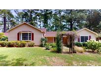 Ranch home with a well-manicured lawn and mature trees at 5141 Nc 56, Franklinton, NC 27525