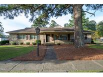 Stone house with a large front porch at 609 W Main St, Benson, NC 27504