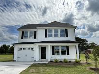 Two story white house with black shutters and a two car garage at 80 Lotus Ave, Smithfield, NC 27577