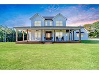 Two story farmhouse with large front porch and expansive lawn at 997 Jackson Rd, Fuquay Varina, NC 27526