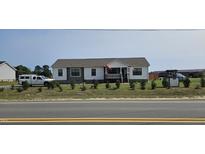 Newly built home with landscaped yard and driveway at 3027 Nc Highway 210, Smithfield, NC 27577