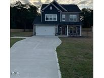 Two-story home with gray siding, a two-car garage, and a paved driveway at 6104 Sunset Lake Rd, Fuquay Varina, NC 27526