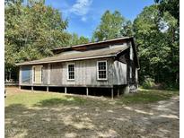 Rustic one-story home with wooden siding needing some repairs at 255 Roberts Ave, Henderson, NC 27537