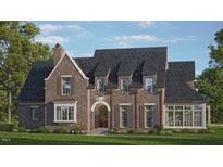 Brick two-story house with a gabled roof, dormers, and landscaping at 401 Marlowe Rd, Raleigh, NC 27609