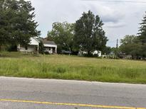 Aerial view of property with two houses and a large yard at 4516 Us 301, Four Oaks, NC 27524