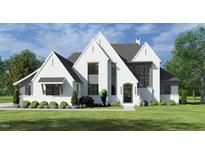 Two-story house with white brick exterior, gray accents, and landscaping at 65 Firefly Overlook, Pittsboro, NC 27312