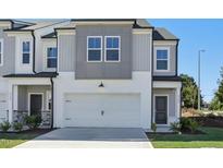 Modern two-story townhome with gray siding and a white garage door at 2100 Regal Dr # 79, Durham, NC 27703