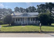 Charming one-story home with a front porch and a well-maintained lawn at 409 W Main St, Spring Hope, NC 27882