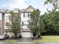 Two-story townhome with two-car garage and manicured lawn at 202 Linden Park Ln, Cary, NC 27519