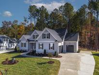 Two-story home with gray siding, stone accents, and a 2-car garage at 994 Browning Pl, Youngsville, NC 27596