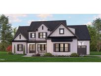 Two-story home with white brick, dark trim, and a metal roof at 142 Lila Dr, Pittsboro, NC 27312