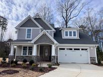 Two-story house with gray siding, white trim, and a two-car garage at 3113 Petrea Ct # 38, Angier, NC 27501