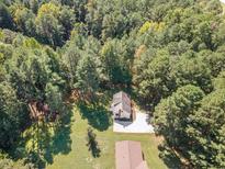 Aerial view of a house nestled in a wooded lot at 5578 Tabbs Creek Church Rd, Oxford, NC 27565