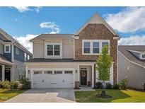 Two story home with stone and shingle accents at 2124 Curry Meadow Way, Durham, NC 27703