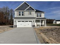 Two-story house with gray siding, white trim, and a two-car garage at 46 Lupin Dr, Smithfield, NC 27577