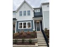 Two-story townhome with gray siding, white trim, and a front porch at 605 Hyperion Aly, Wake Forest, NC 27587