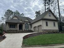 Two-story house with stone accents and a three-car garage at 22005 Turner, Chapel Hill, NC 27517