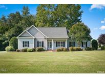 Ranch style home with a well-manicured lawn at 15 Meadow View Ct, Fuquay Varina, NC 27526