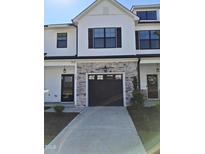 Two story home with stone and white accents at 727 Putney Hill Rd, Zebulon, NC 27597