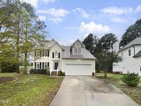 Two-story house with attached garage and landscaped yard at 104 Deerwalk Ct, Cary, NC 27513