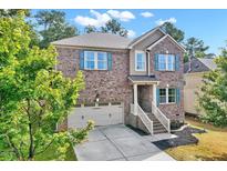 Brick two-story house with two car garage and landscaping at 306 Knollcrest Ln, Knightdale, NC 27545