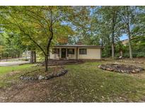 Cozy ranch home with landscaped yard, stone borders, and porch at 9336 Baileywick Rd, Raleigh, NC 27615