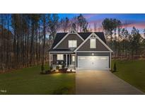 Charming two-story home with a two-car garage and inviting front porch at 145 Leisure Ln, Louisburg, NC 27549