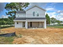 Two-story home with gray siding and attached garage at 23 Alderman Ct, Dunn, NC 28334