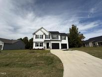 Two-story home with black accents and a long driveway at 54 Bonsai Way, Four Oaks, NC 27524