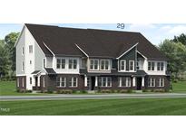 Modern three-story townhome with dark brick and light siding at 2415 Adrift Rd, Fuquay Varina, NC 27526