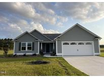 Newly built gray house with white garage doors at 53 Grace Ridge Ct, Benson, NC 27504