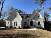 White two-story home with gabled rooflines and a covered entryway at 4501 Bartlett Dr, Raleigh, NC 27609