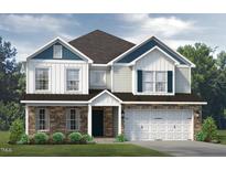 Two-story home with stone and shingle exterior, two-car garage, and landscaping at 1935 Darrell Dr # 8, Graham, NC 27253