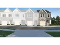 Modern 3-story townhome with stone accents and a 2-car garage at 829 Windmill Palm Dr, Zebulon, NC 27597