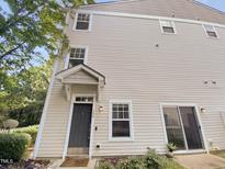 Beige three-story siding home with dark gray door at 330 Gilman Ln # 106, Raleigh, NC 27610