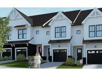 Modern three-unit townhome building with attached garages at 4047 Elk Creek Ln # 13, Raleigh, NC 27612