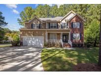 Two-story brick home with attached garage and landscaped yard at 2 Piney Ridge Ct, Durham, NC 27712