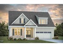 Charming two-story house with a brick facade and attached garage at 2541 Lillian Woods Way, Wendell, NC 27591