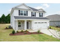 Two story house with white siding and stone accents at 546 Middleton Ct, Sanford, NC 27330