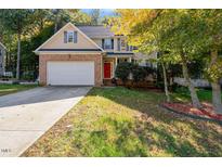Brick home with two-car garage and landscaped yard at 65 Applegate Dr, Franklinton, NC 27525