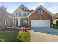 Brick home with two-car garage and landscaping at 9 Oxmoor Dr, Durham, NC 27703