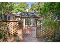 Brick house with ornate gate and landscaped walkway at 675 Whitehurst, Pittsboro, NC 27312