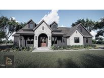 Modern farmhouse exterior with stone accents at Lot 5 Joyful Creek Trl, Zebulon, NC 27597